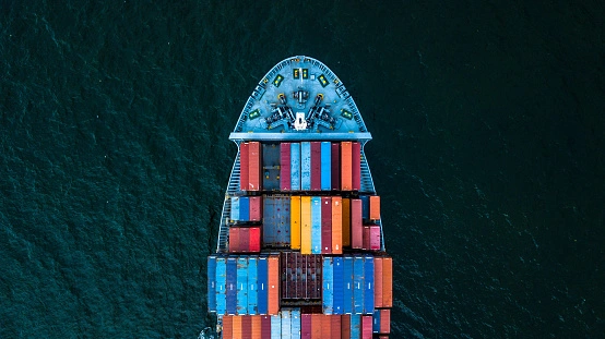 A cargo ship with shipping containers for parcel delivery from Calgary, Canada to France Europe