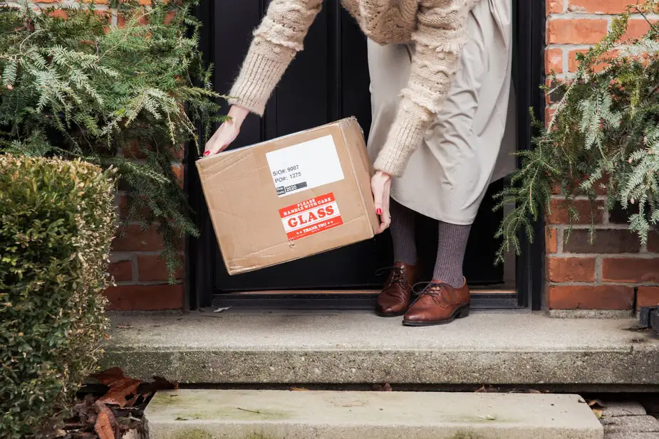 Woman collecting delivered parcel